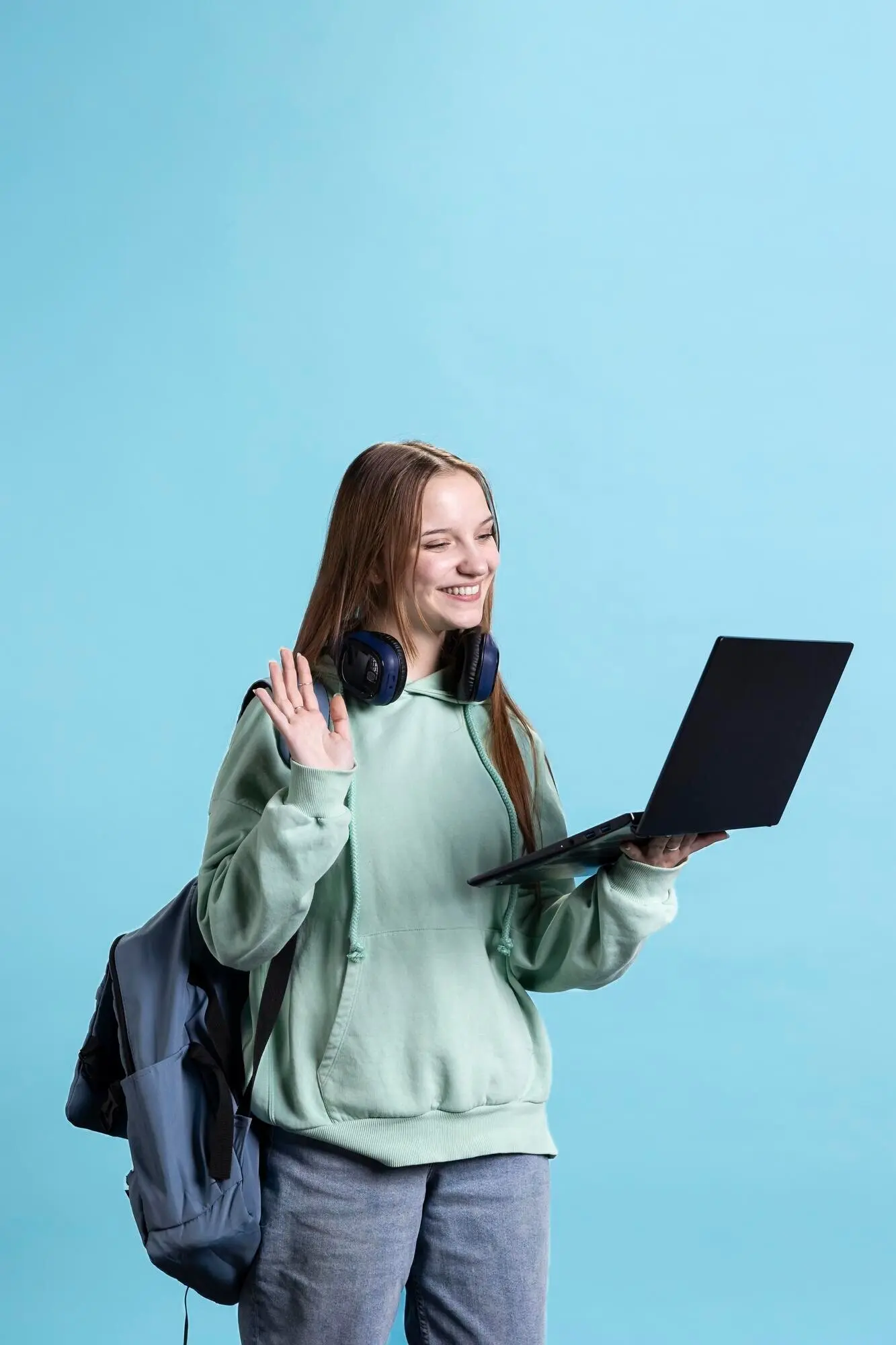 Lächelnde Frau in einer Telekonferenz, die einen Laptop benutzt.